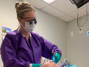Photograph of Anna working on a patient